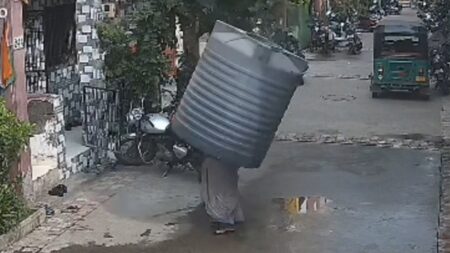 Video captures water tank falling on woman — but she miraculously escapes injury