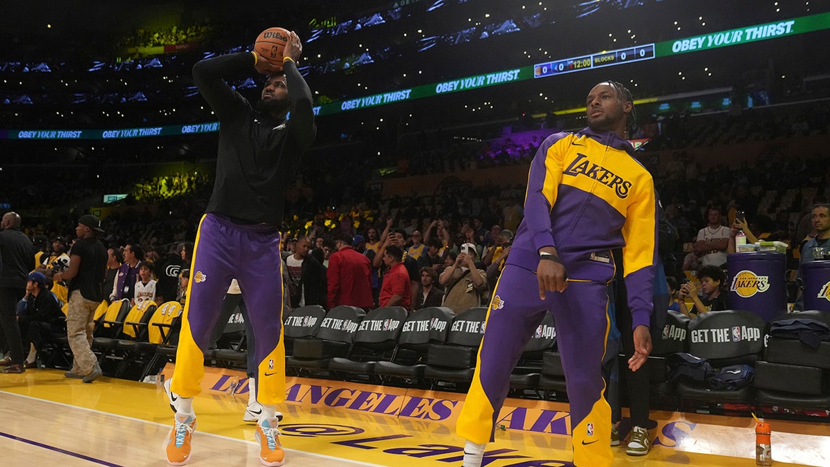 LeBron and Bronny James warm up