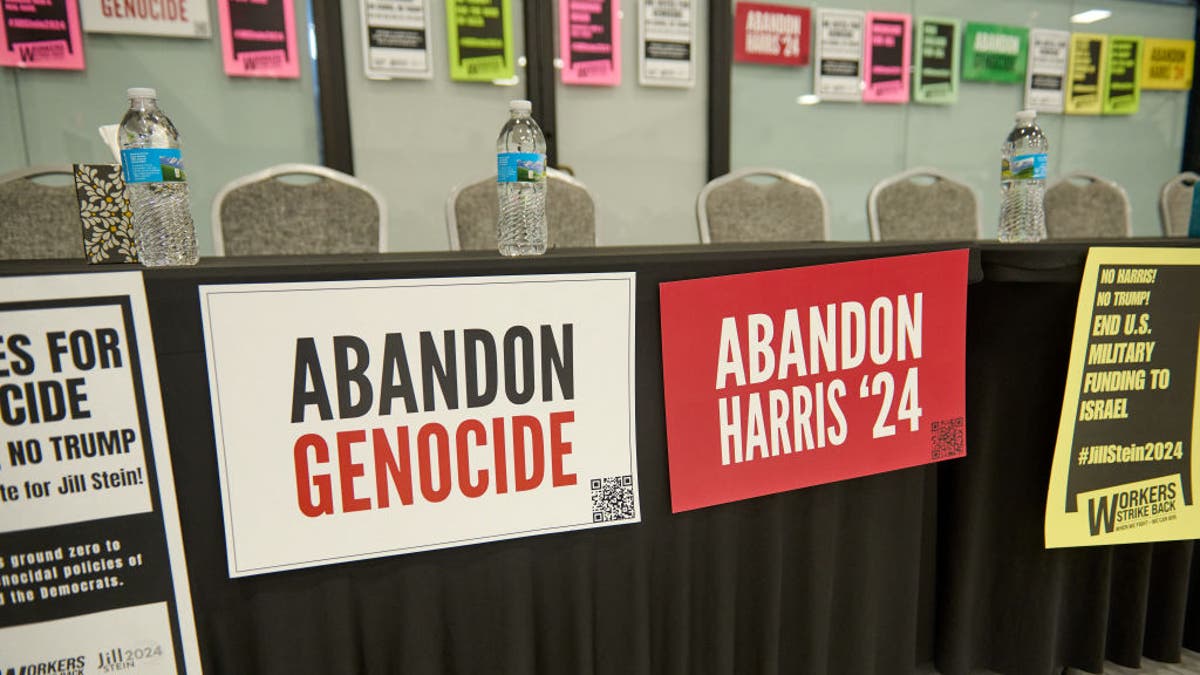 Abandon Genocide, Abandon Harris signs on table