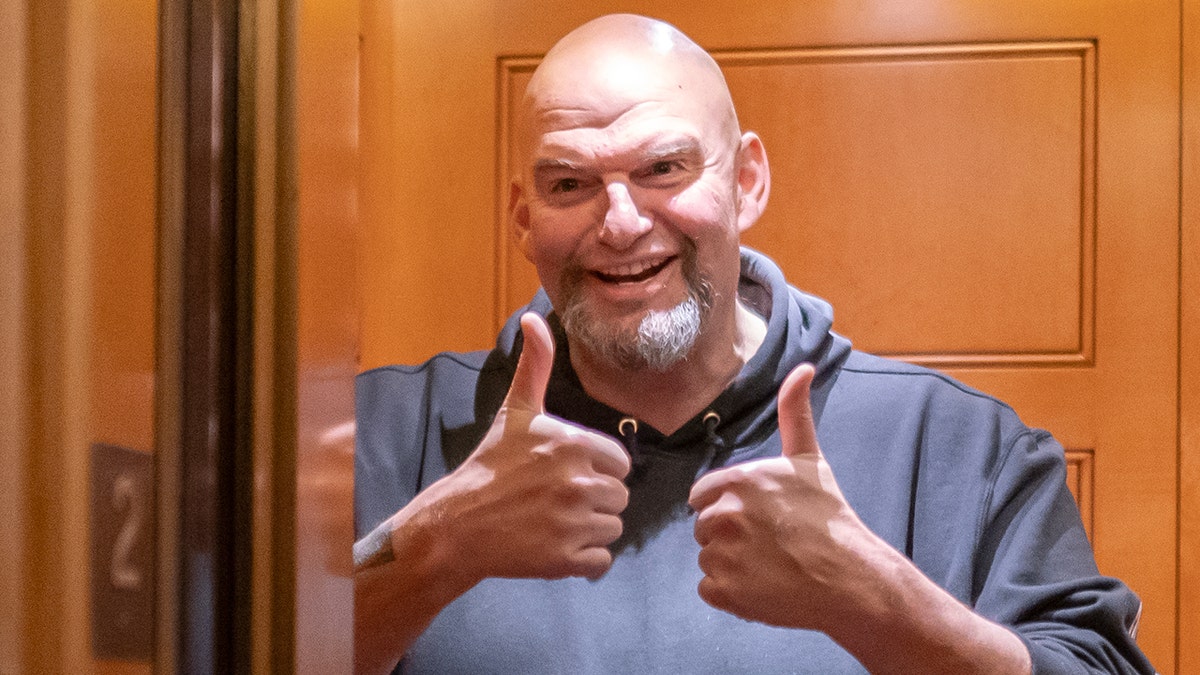 Sen. John Fetterman smiles while putting both his thumbs up