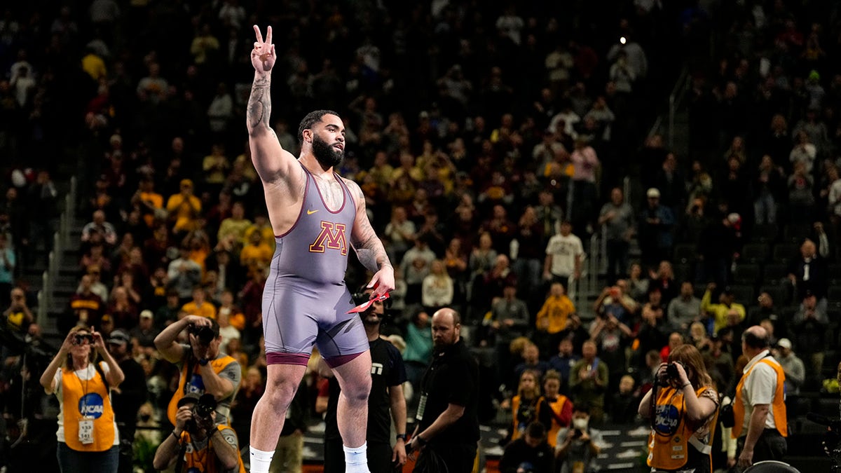 Wrestler Gable Steveson raises his arm