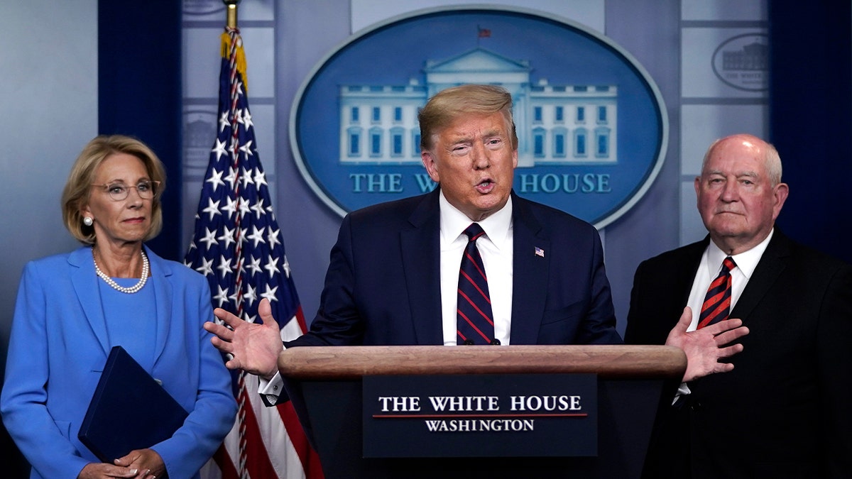 Then-President Trump, then-Secretary of Education Betsy DeVos and then-Secretary of Agriculture Sonny Perdue in the press briefing room of the White House on March 27, 2020 in Washington, D.C.