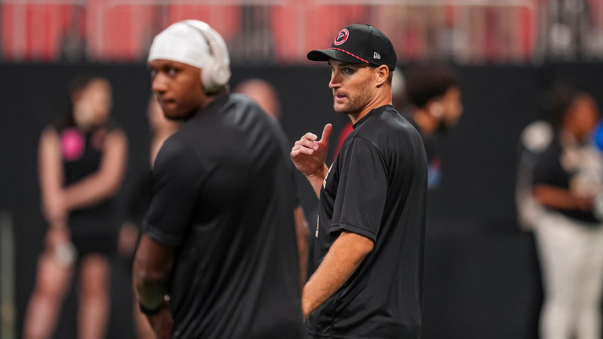 Kirk Cousins looks at Michael Penix Jr.