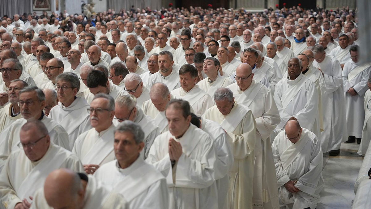 Deacons pray for the pope