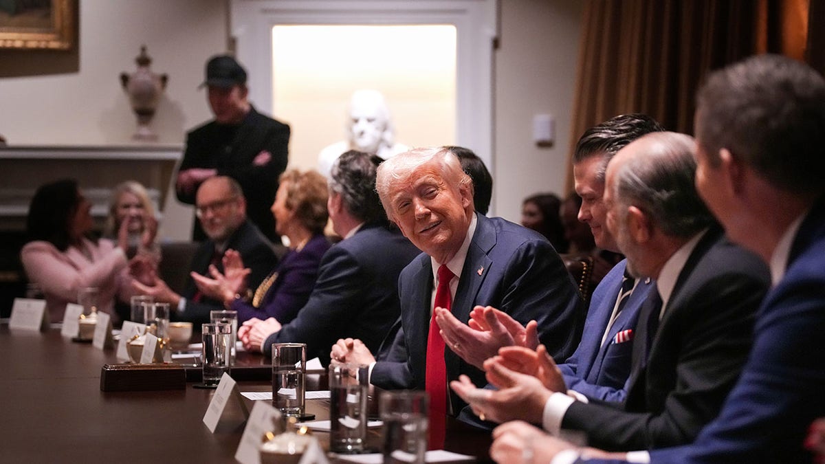 Trump sits at table during Cabinet meeting