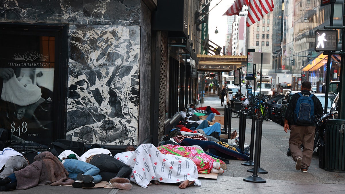 nyc migrants sleep on sidewalk