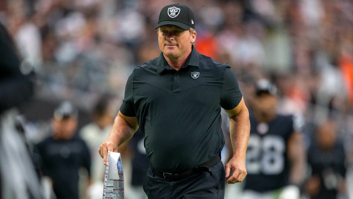 Jon Gruden runs off field