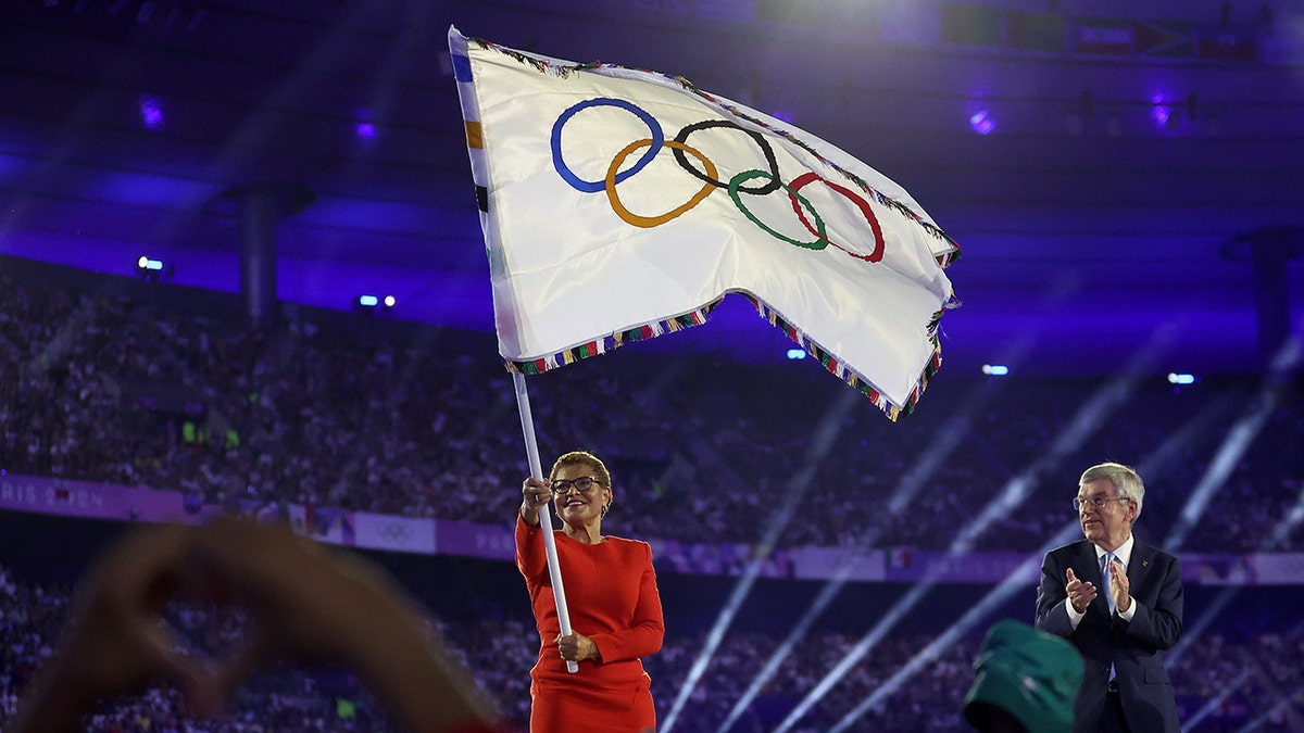 Karen Bass waves Olympic flag