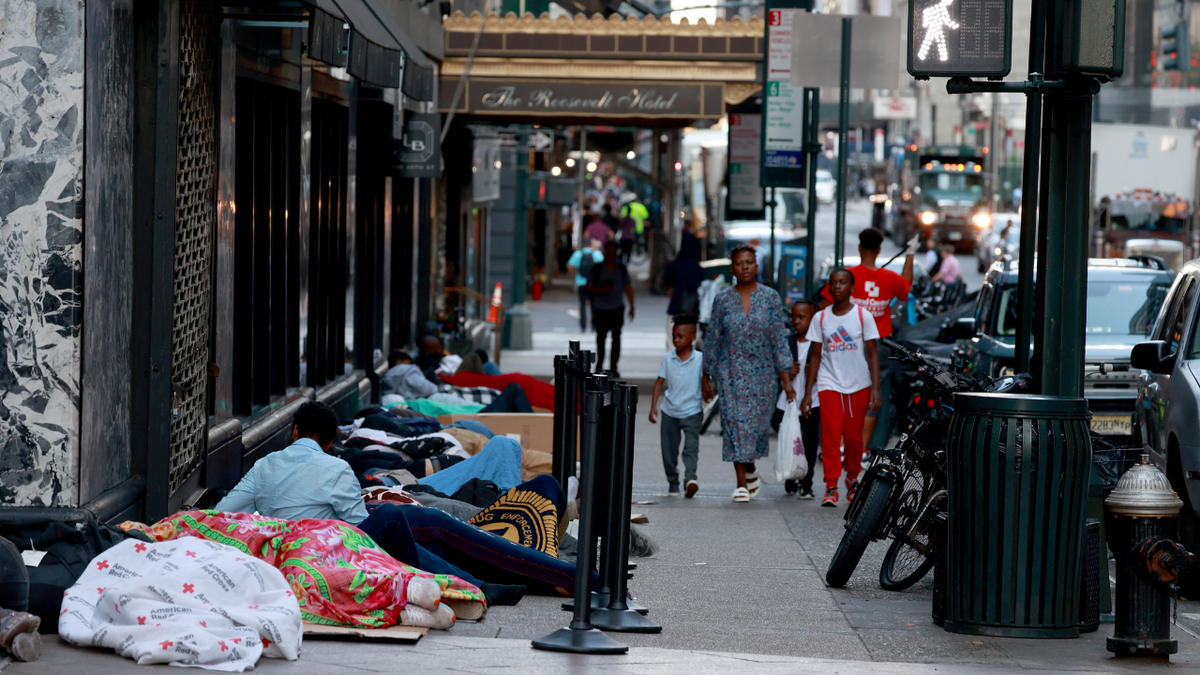 migrants sleeping outside Manhattan hotel