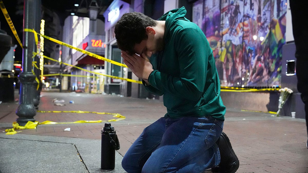 Man praying near Bourbon Street