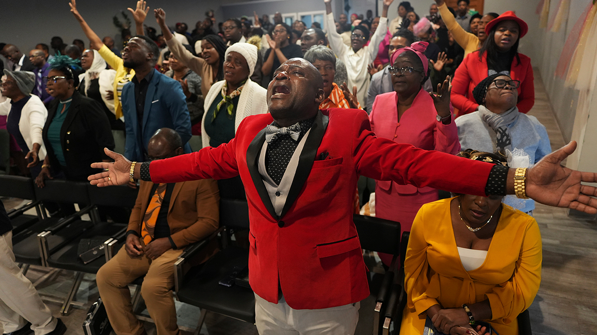 Jean-Michel Gisnel cries out while praying