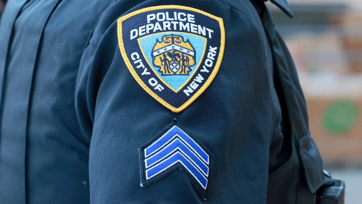 CLoseup of NYPD uniform showing a sergeant's chevron patch on a policeman's right arm