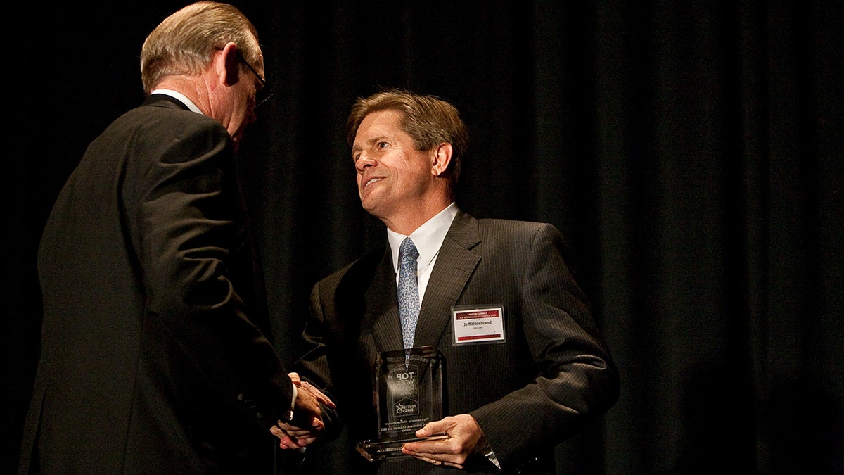 Jeffery Hildebrand receiving an award