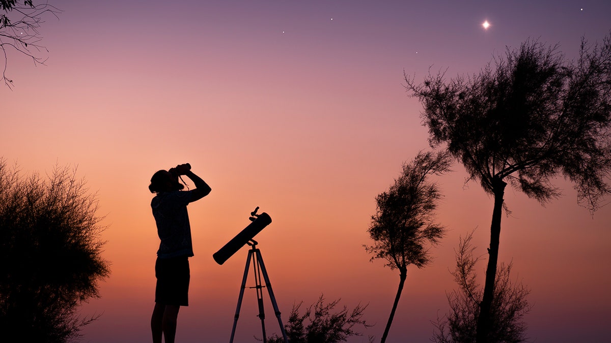 man with telescope and binoculars