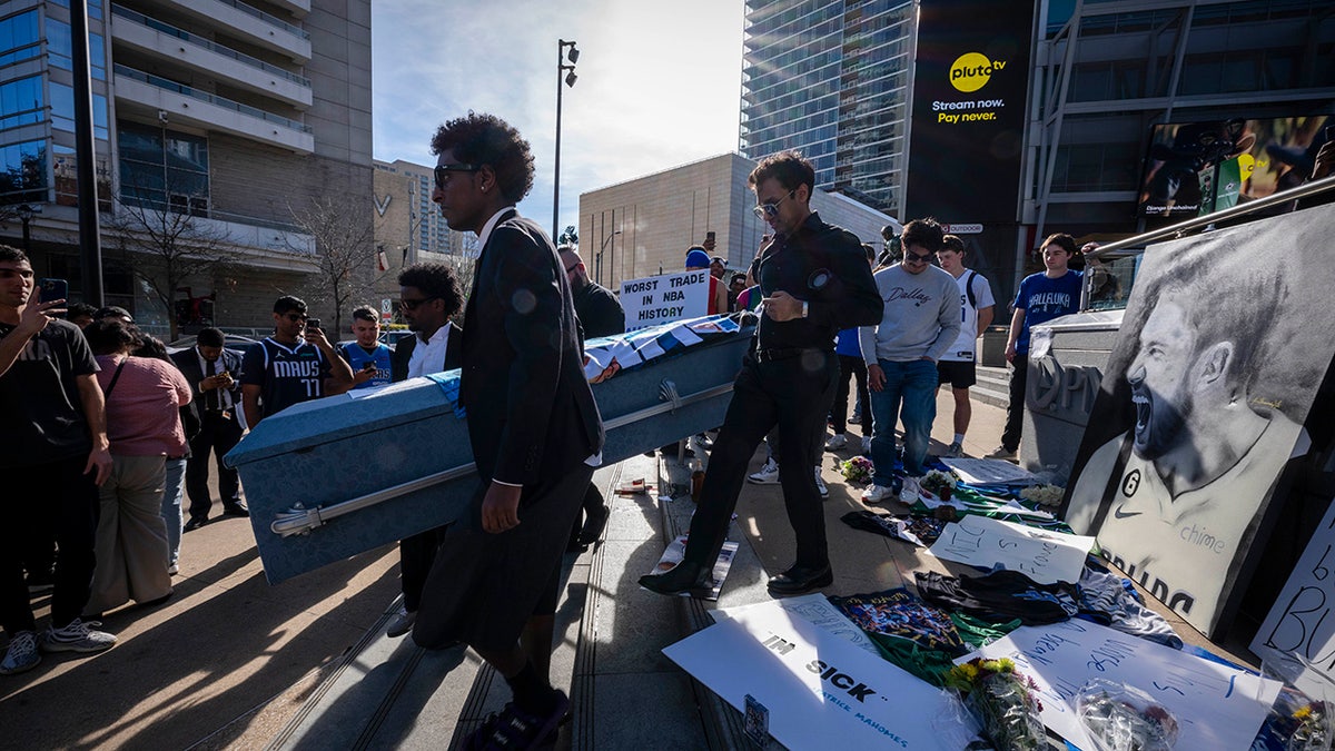 Mavericks fans carry coffin outside arena