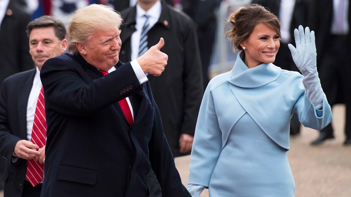 JANUARY 20: President Donald Trump and first lady Melania Trump walk in their inaugural parade on January 20, 2017 in Washington, DC. Donald Trump was sworn-in as the 45th President of the United States. 