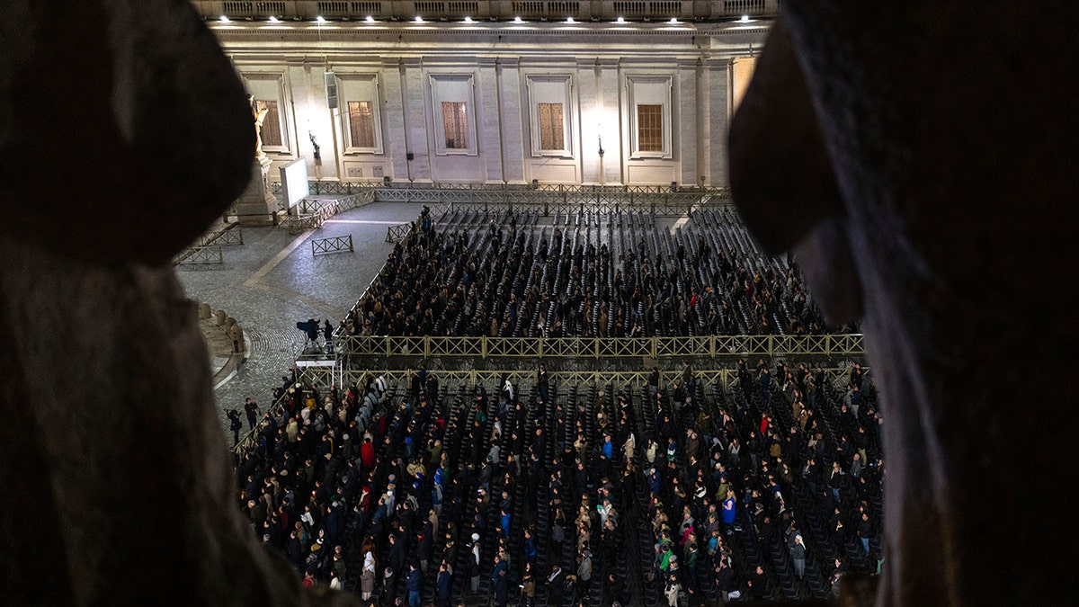 Catholic faithful attend a nightly rosary prayer service for the health of Pope Francis in St. Peter's Square at the Vatican.