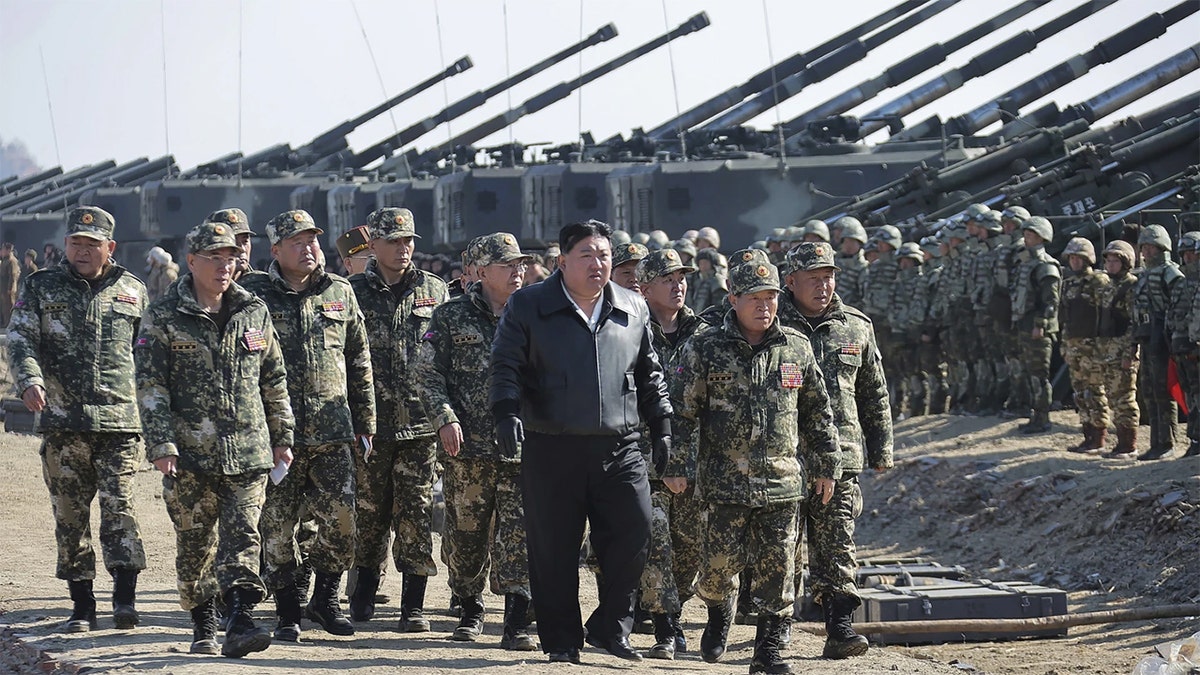 North Korean soldiers marching with Kim Jong Un