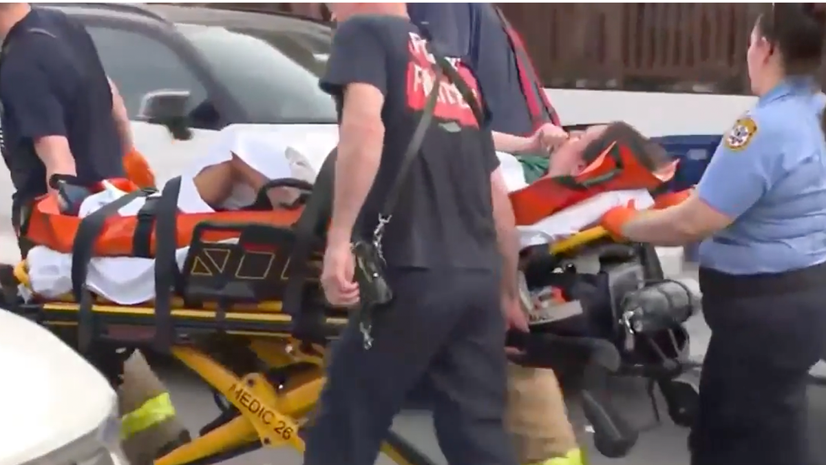 A person is taken by stretcher after the roof collapse