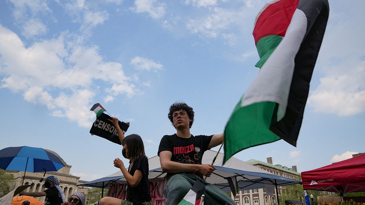 A protester holds a Palestinian flag as students rally on Columbia University campus