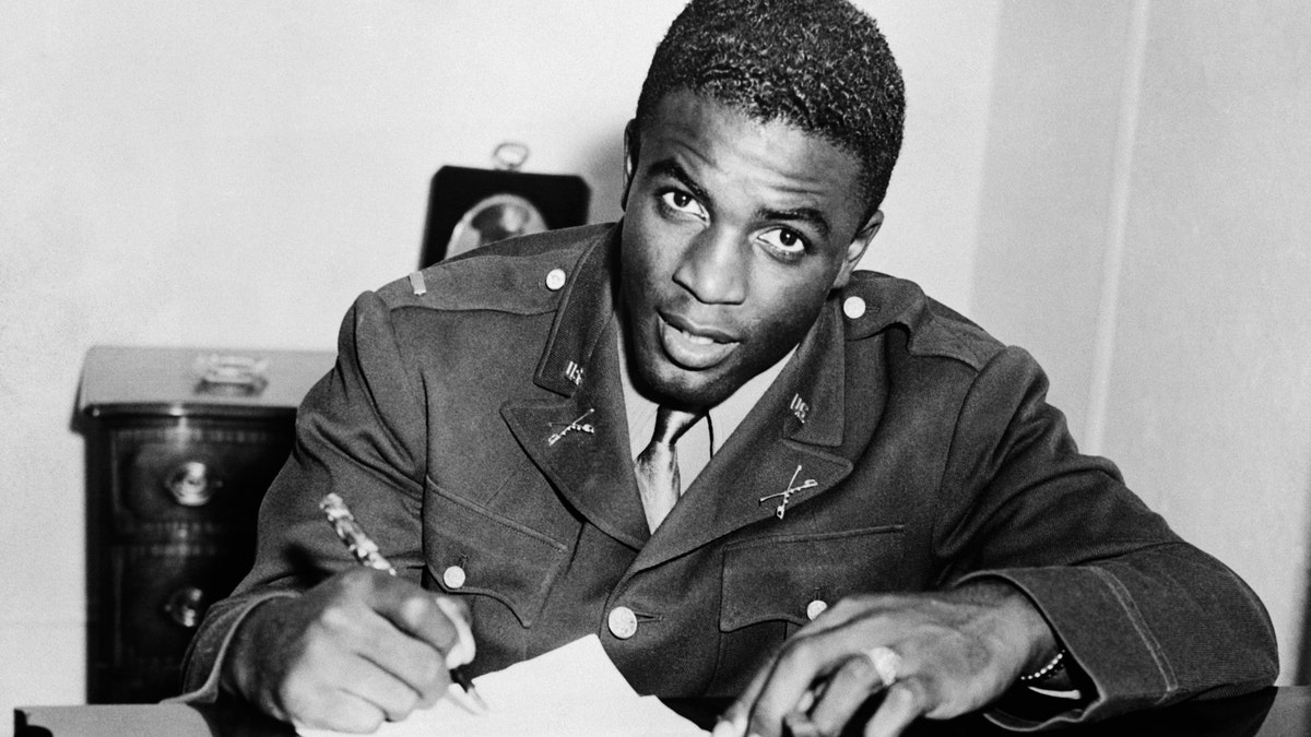 Jackie Robinson signs with a baseball team