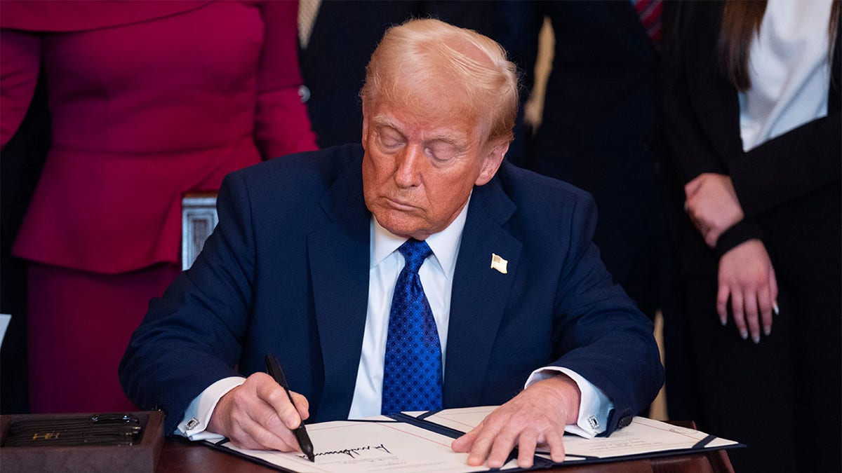 President Donald Trump signs the Laken Riley Act during in the East Room of the White House, Wednesday, Jan. 29, 2025, in Washington. (AP Photo/Evan Vucci)