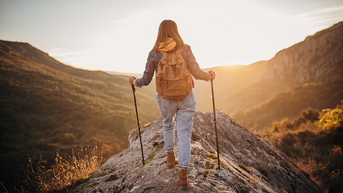 A woman overlooks scenery during a hike.