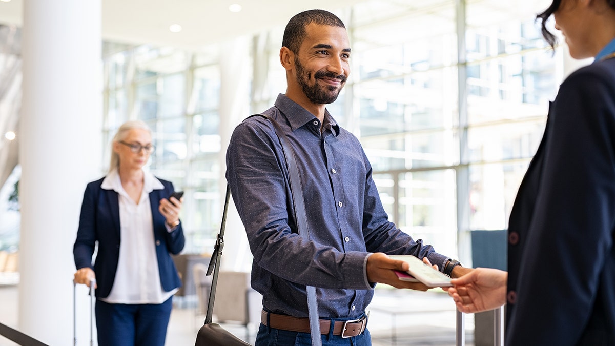 man with gate agent about to board