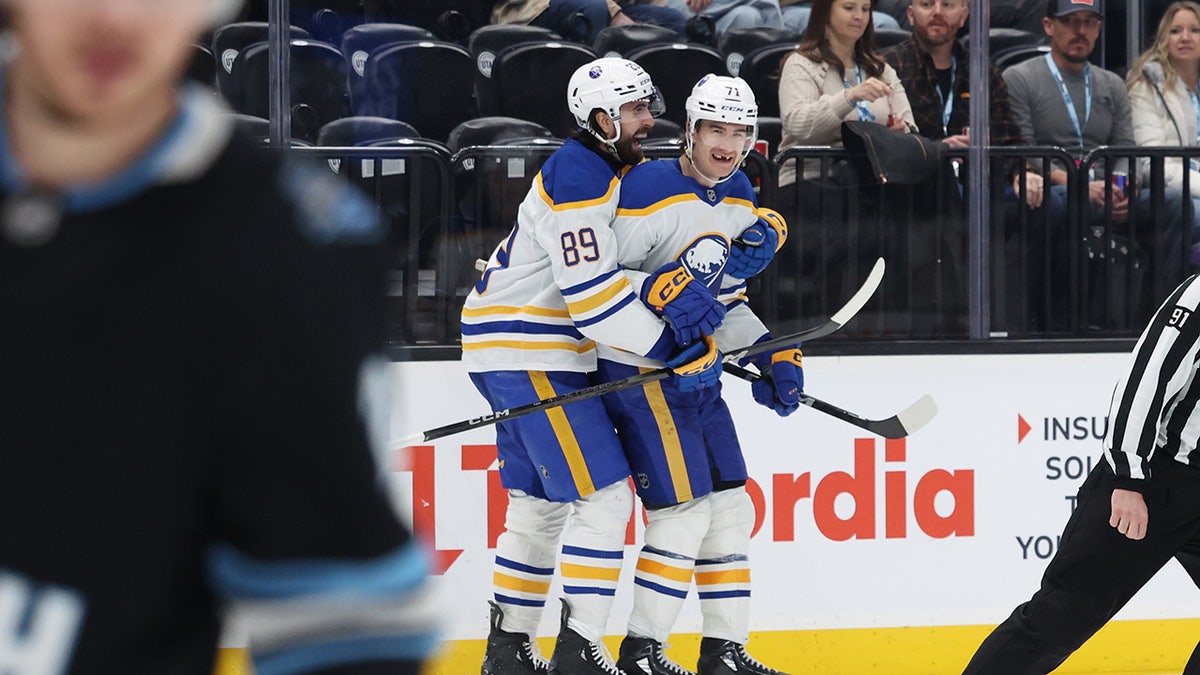 Ryan McLeod celebrates with Alex Tuch