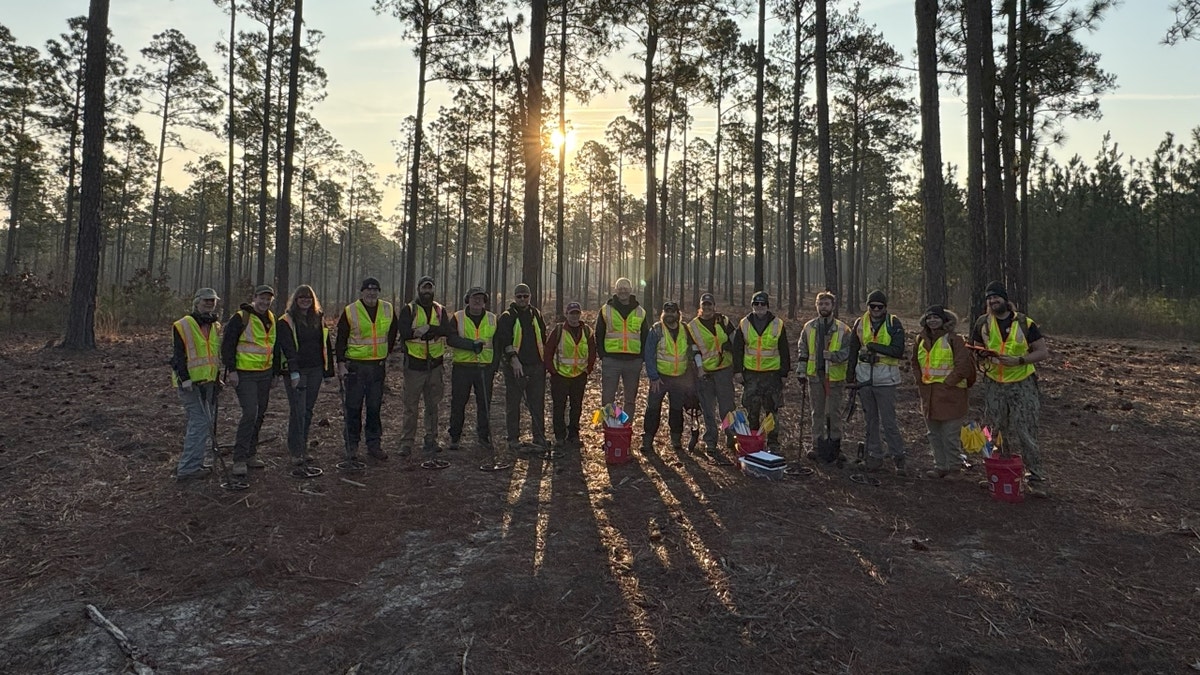 Veterans standing together in field