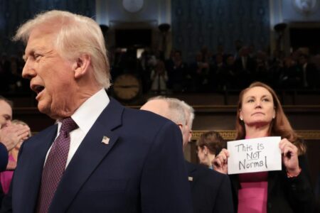 GOP lawmaker rips ‘This is not normal’ sign out of protesting Dem rep’s hands before Trump speech