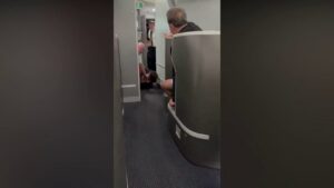 American Airlines passenger restrained, knocked to floor while barging into cockpit: video