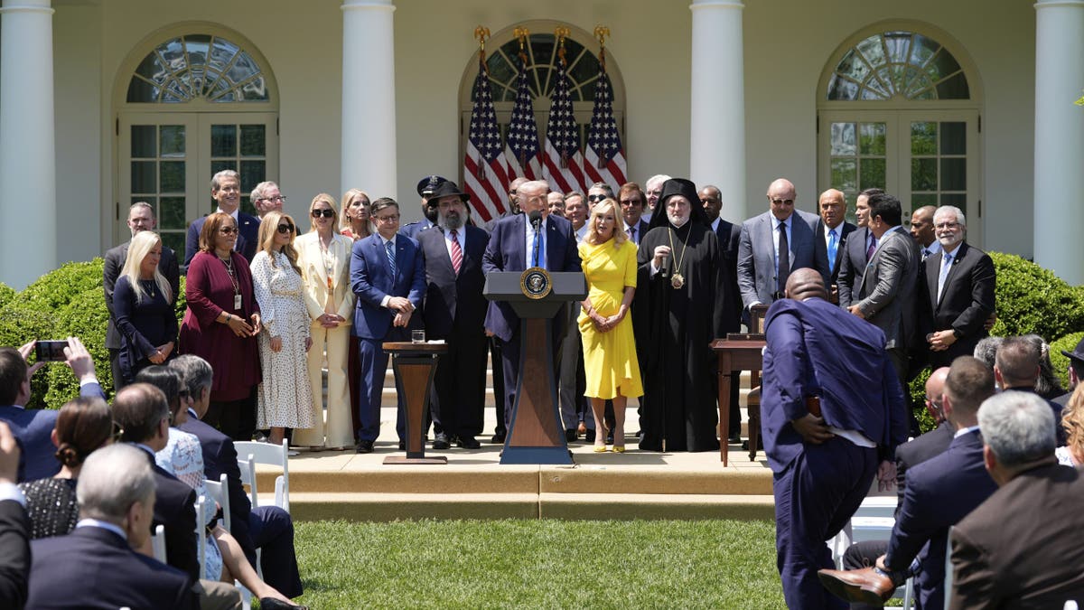 President Donald Trump calls people to the podium to stand with him during a National Day of Prayer event in the Rose Garden of the White House, Thursday, May 1, 2025, in Washington. (Alex Brandon/The Associated Press)