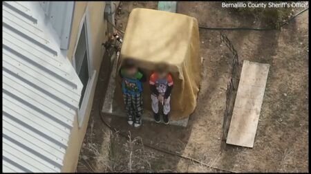 Boys, ages 7 and 9, seen in armed standoff receiving assistance from deputies