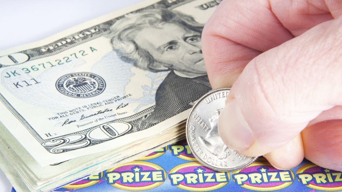Lottery scratcher with cash