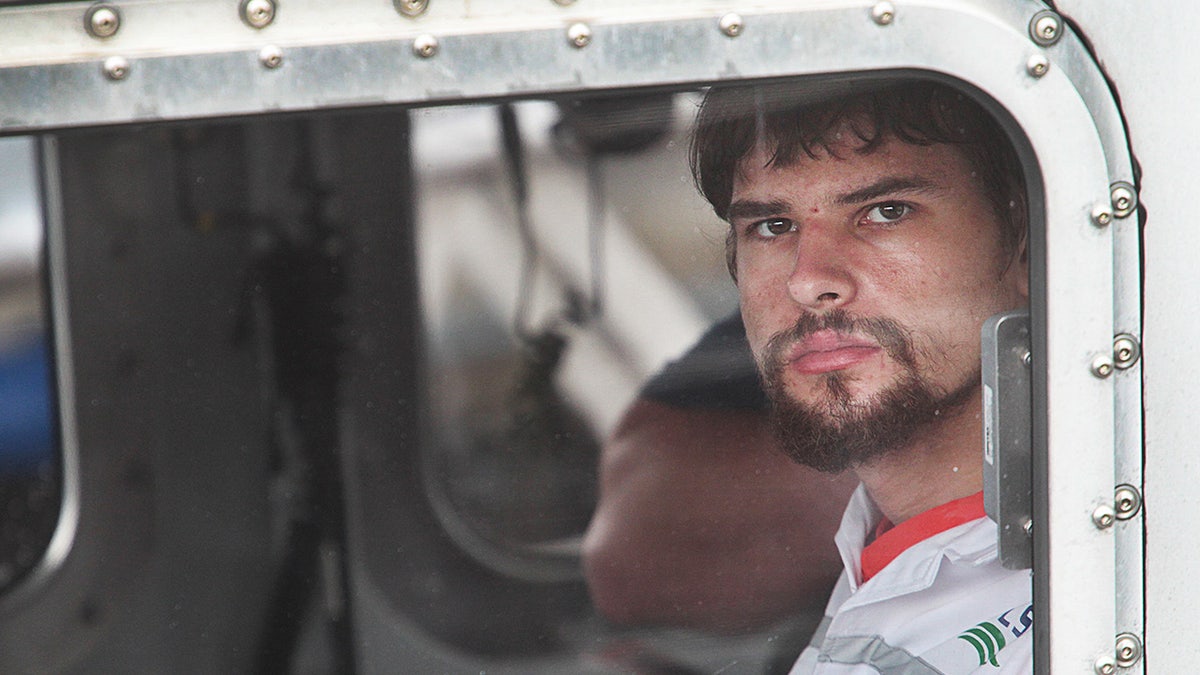 A close-up of Nathan Carman looking directly at the camera from inside a boat.