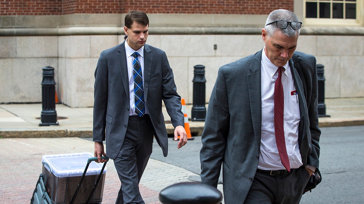 Nathan Carman walking next to his attorney outside of court.