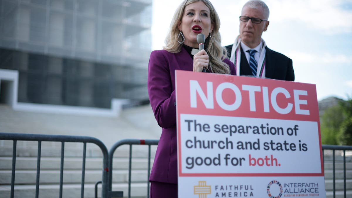 Rev. Shannon Fleck of Faithful America speaks as Rev. Paul Brandeis Raushenbush of Interfaith Alliance listens during a news conference outside the Supreme Court on April 30, 2025.