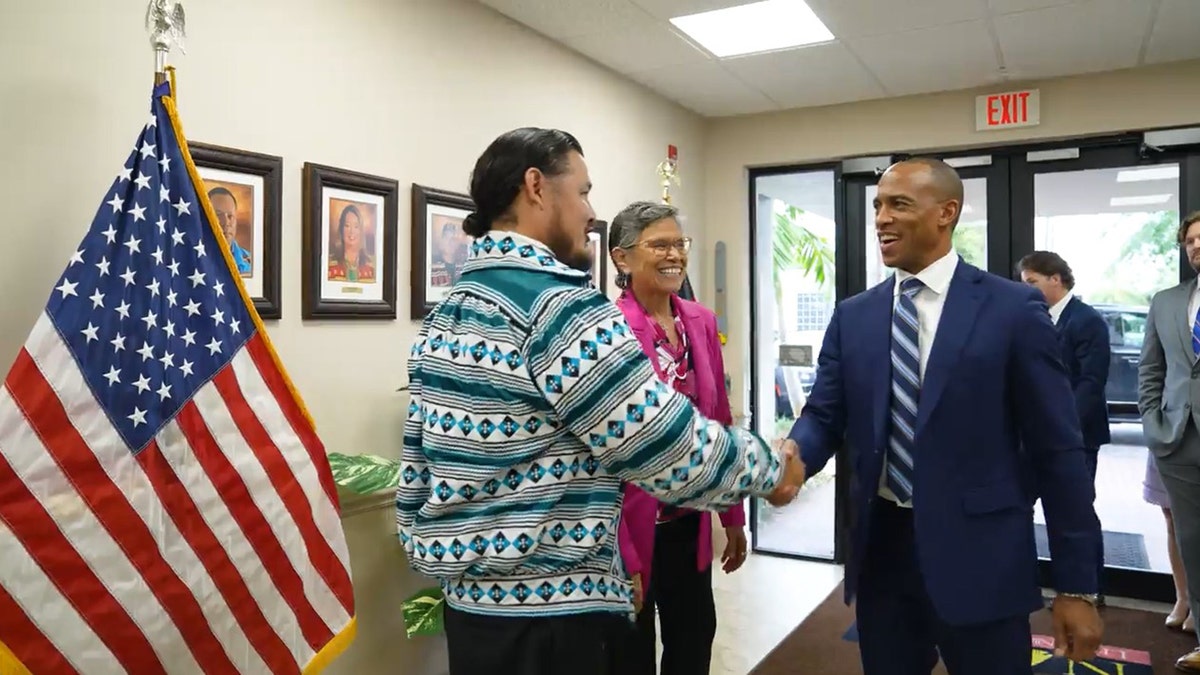 HUD Sec. Scott Turner shakes hands