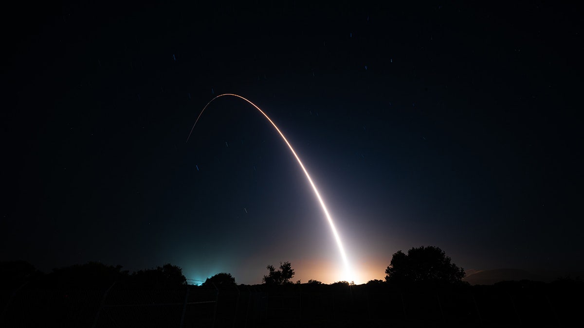 ICBM missile arc against night sky