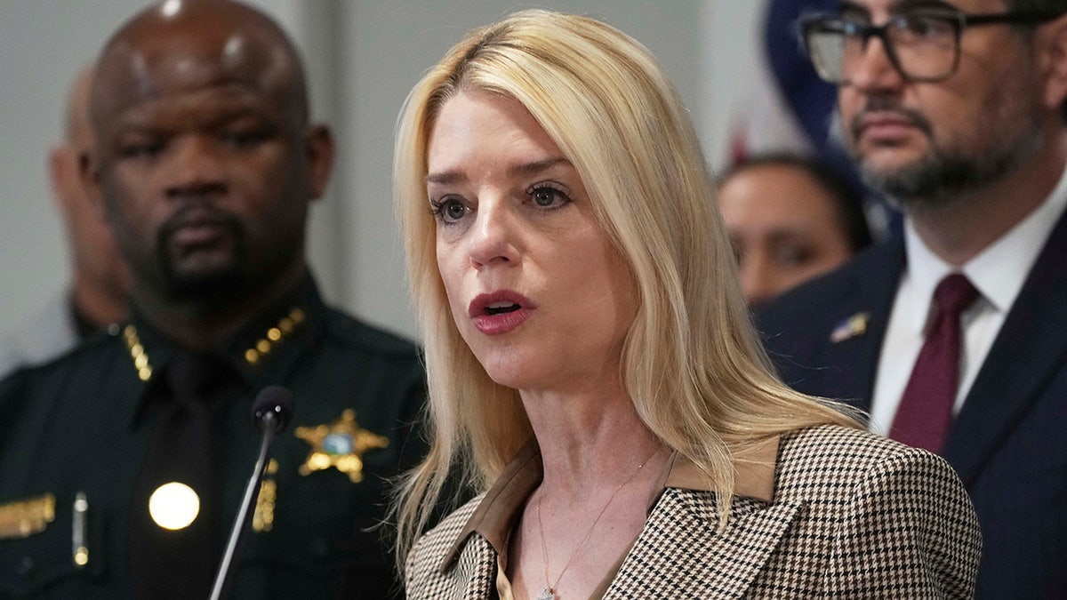 Pam Bondi speaking at a microphone