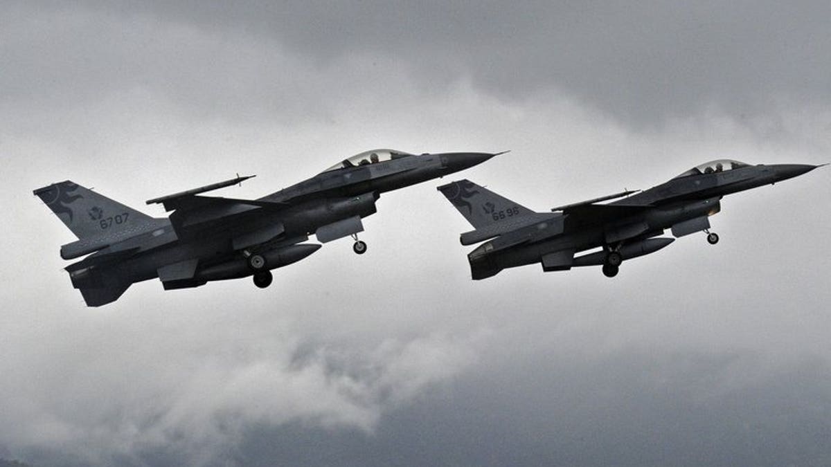 Two F-16 fighters take-off from the Hualien air force base in eastern Taiwan, on January 23, 2013. Taiwan's air force will be armed with "smart" munitions before the year's end that could be used against any Chinese invasion by striking airfields and harbours on the mainland, according to a report in the China Times.