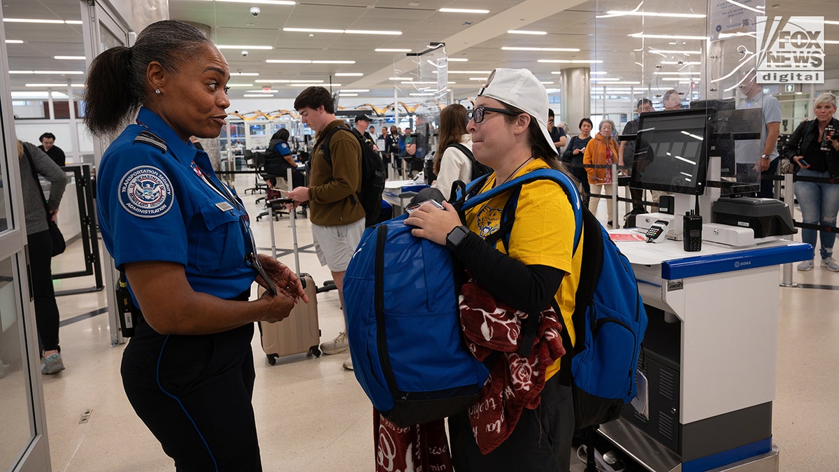 Young travelers present REAL ID's at the airport on day one of the program being in effect