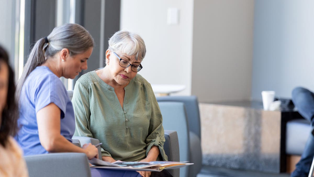 Senior consulting with healthcare worker