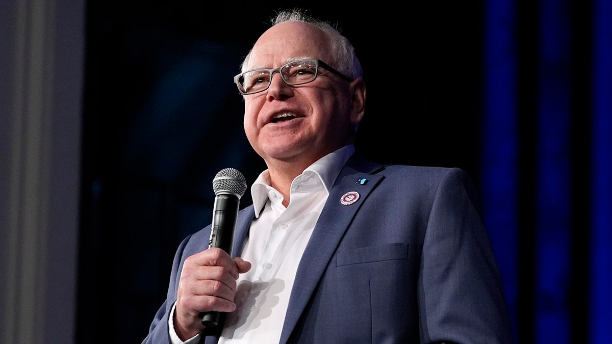 Tim Walz closeup shot holding microphone.