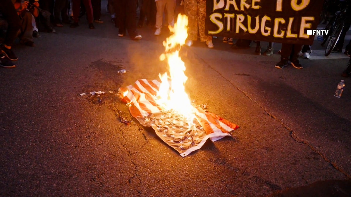 Anti-ICE protesters in Los Angeles burn an American flag in Los Angeles.