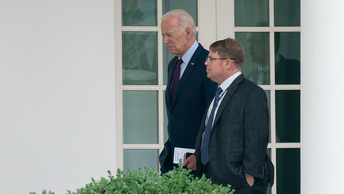 then President Biden walking with his white house doc