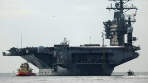 USS Nimitz carrier strike group sailing toward Middle East ahead of schedule, US official says