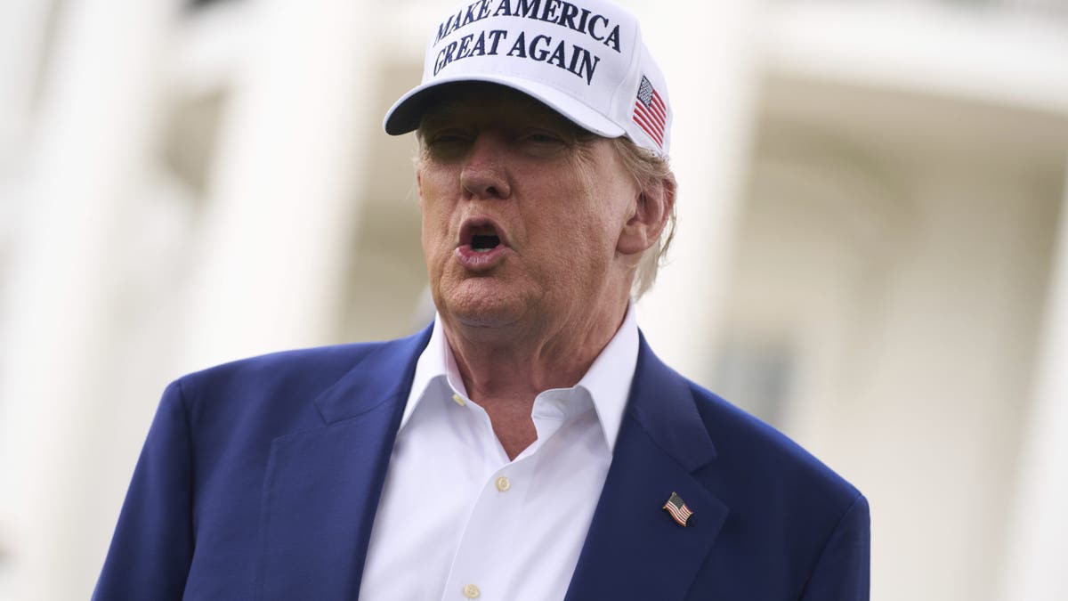 President Donald Trump talks with reporters before a flag pole is installed on the South Lawn of the White House, Wednesday, June 18, 2025, in Washington. (AP Photo/Evan Vucci)
