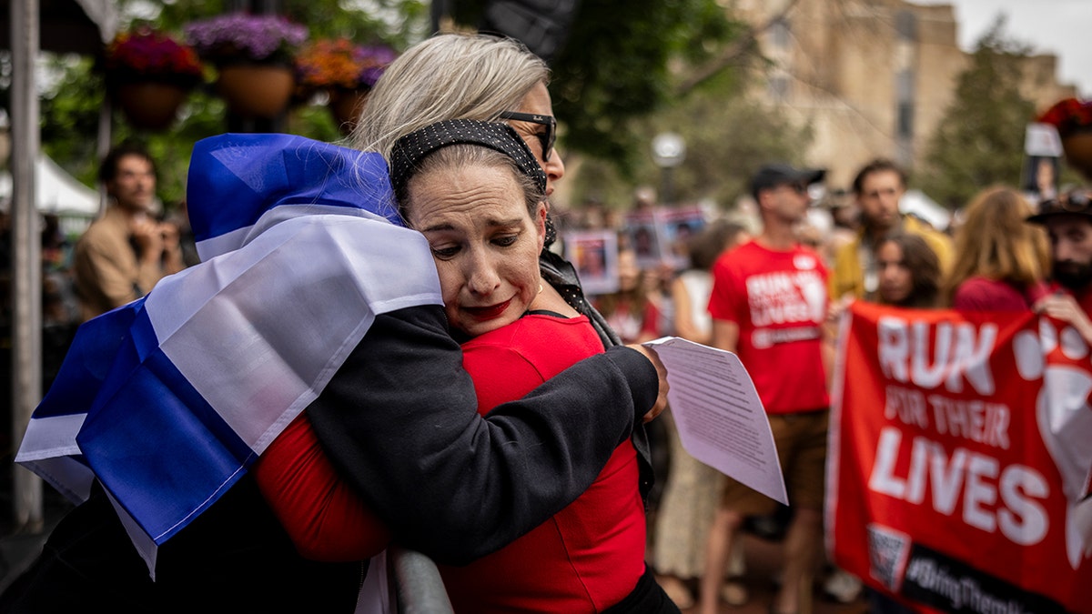 Boulder attack aftermath, two woman hugging